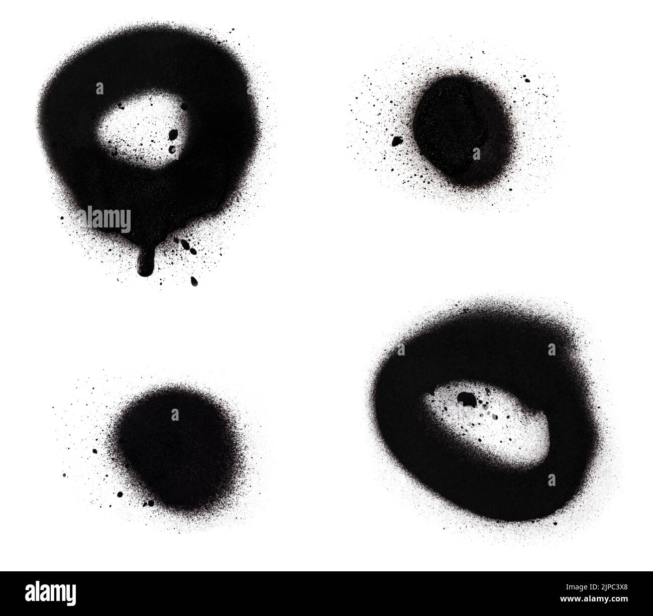 Close-up of two black spray paint spots and circles with splashes and drips, isolated on white background. Stock Photo