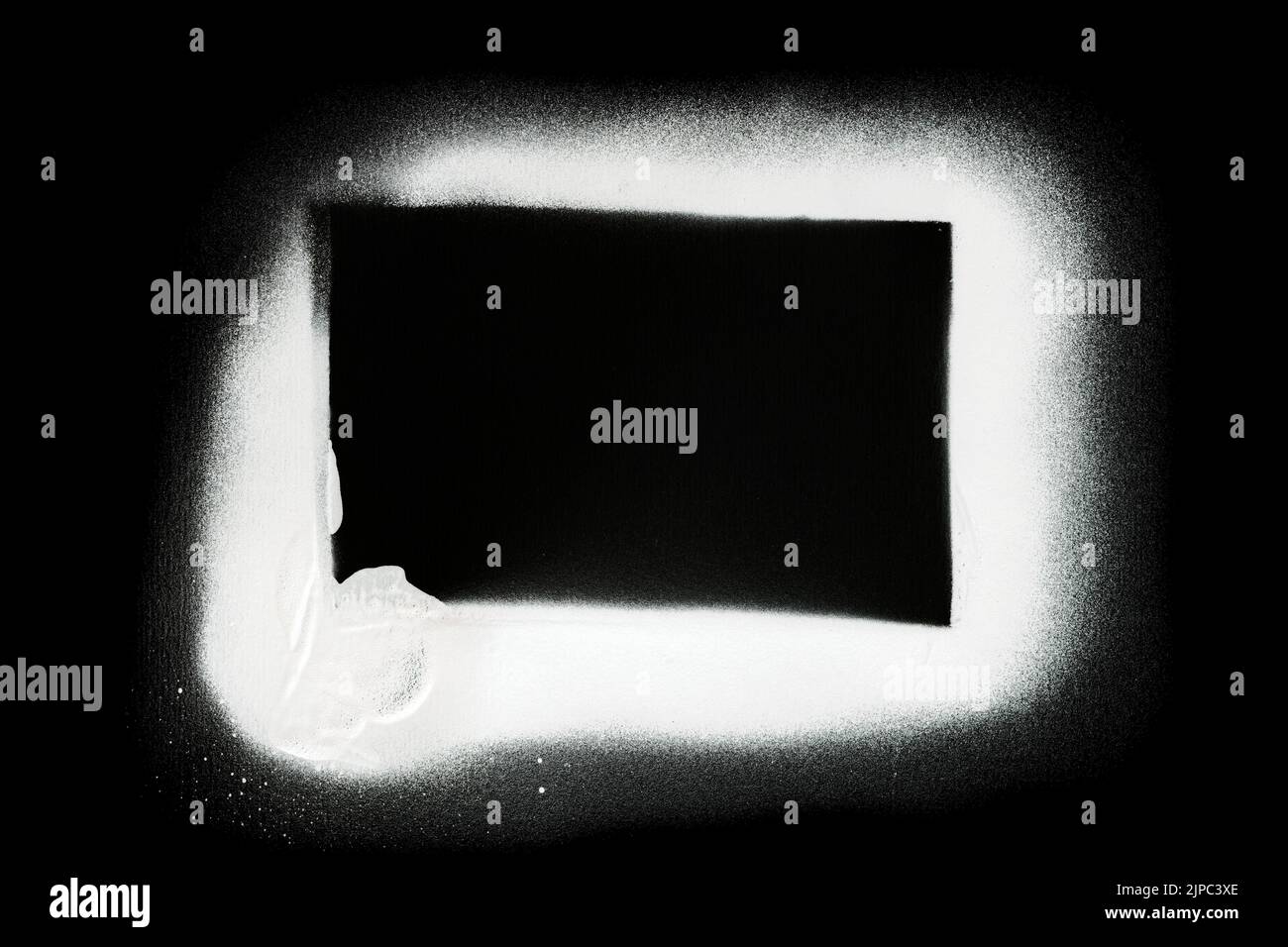 Close-up of a black rectangle made with white spray paint and stencil. Isolated on black background. Copy space. Stock Photo