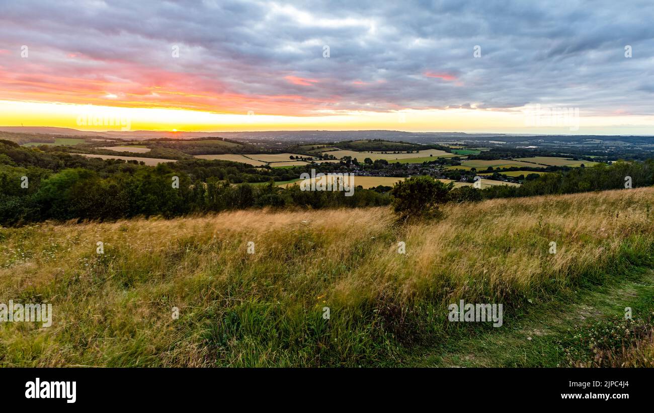Stunning scenery of celestial body in the cloudy sky at dramatic sunrise over South Harting, UK Stock Photo