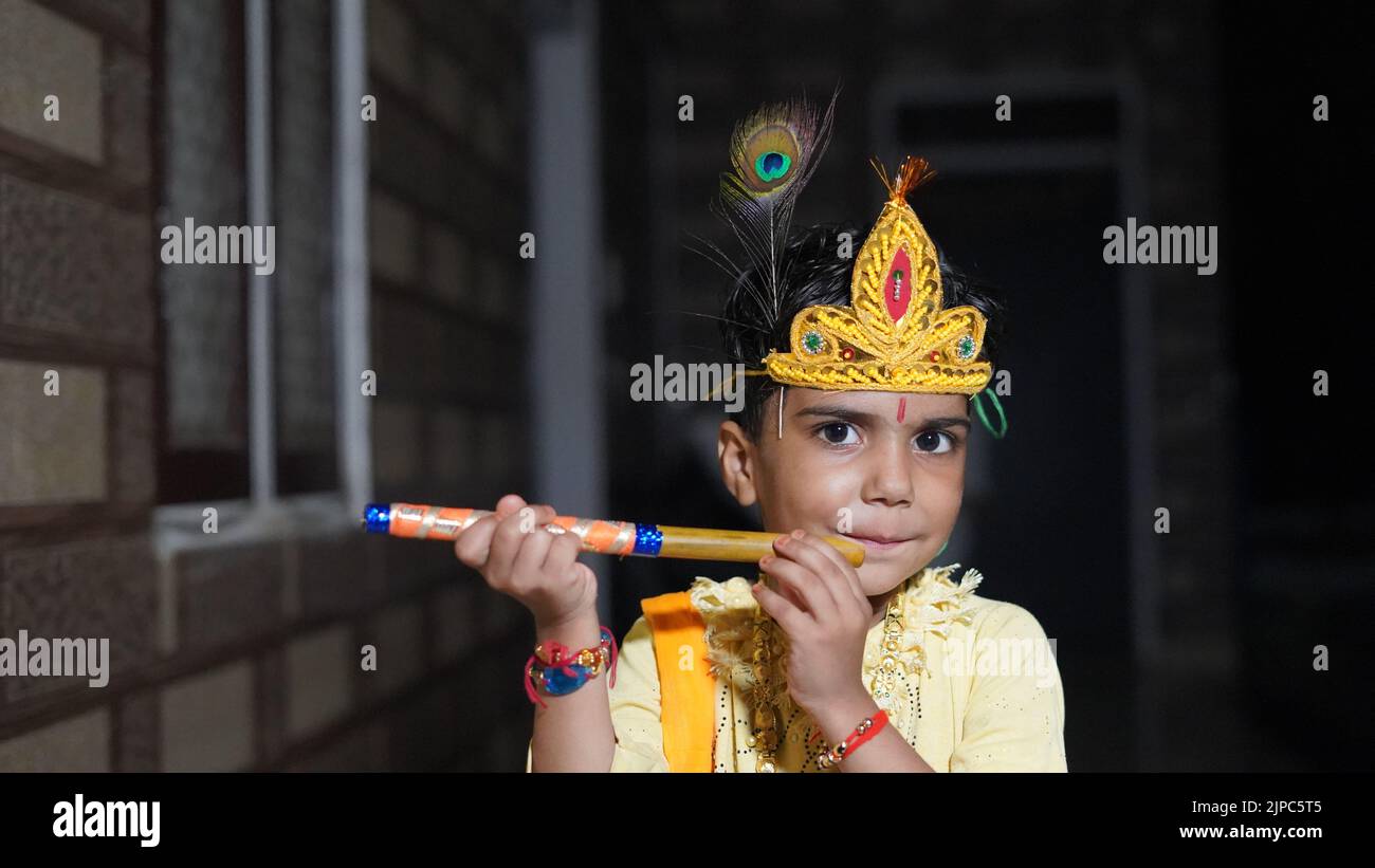 Asian boy posing as Shri krishna or kanhaiya on fancy dress or Gokulashtami festival. Stock Photo
