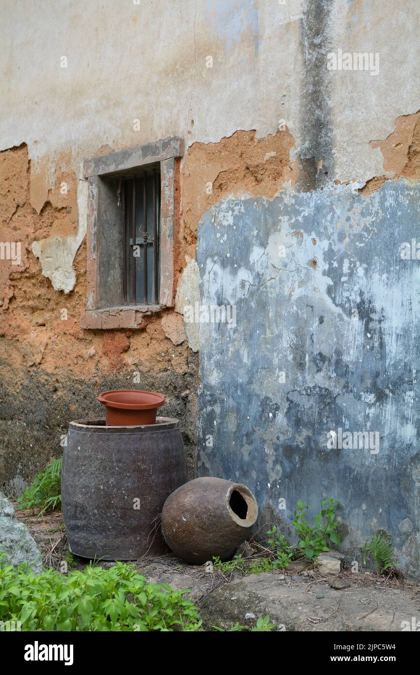 Clay pot and barrel outside a country home in rural China Stock Photo