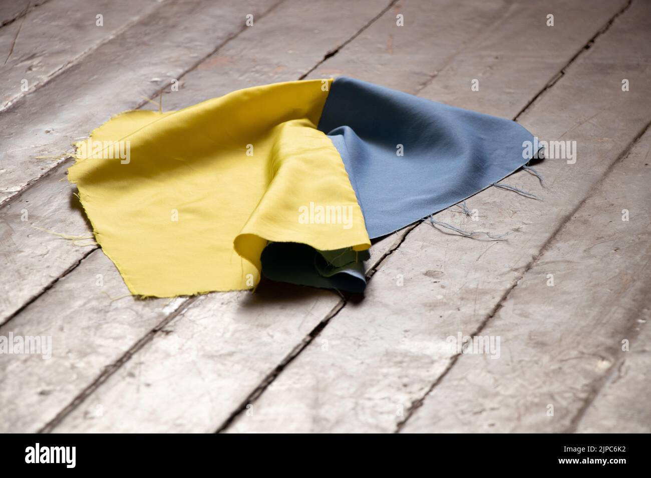 The national flag of Ukraine thrown on the floor of a house in Ukraine, a tragedy in every house in the country of Ukraine 2022 Stock Photo
