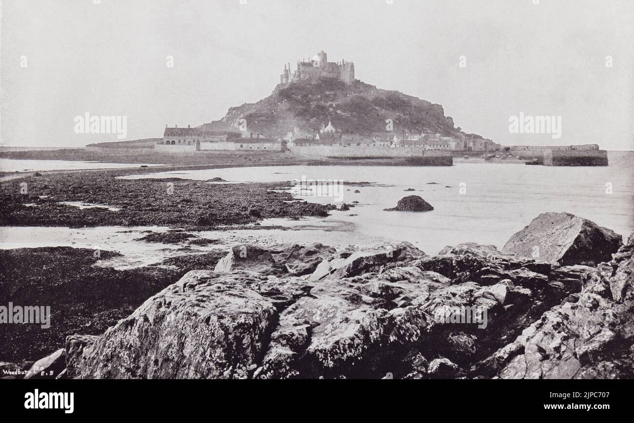 St. Michael's Mount, Mount's Bay, Cornwall, England, seen from the rocks at Marazion in the 19th century.  From Around The Coast,  An Album of Pictures from Photographs of the Chief Seaside Places of Interest in Great Britain and Ireland published London, 1895, by George Newnes Limited. Stock Photo