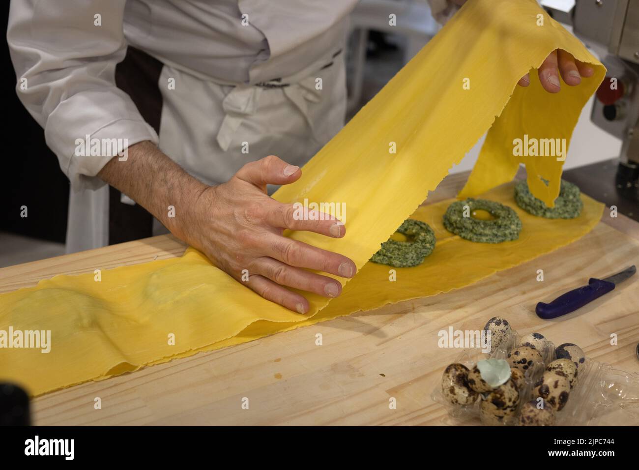 Preparation of Ravioli Italian Pasta with Spinach and Quail Eggs Stock
