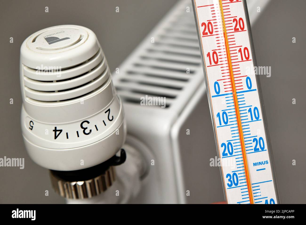 Illustration photo - a thermostat on a modern heating system in an apartment. Measurement and regulation of heating temperature due to skyrocketing en Stock Photo