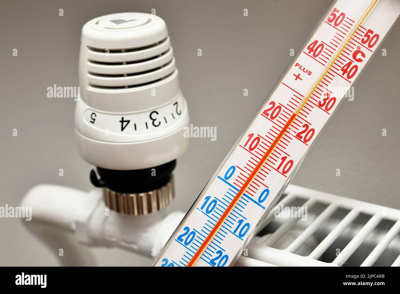 Illustration photo - a thermostat on a modern heating system in an apartment. Measurement and regulation of heating temperature due to skyrocketing en Stock Photo