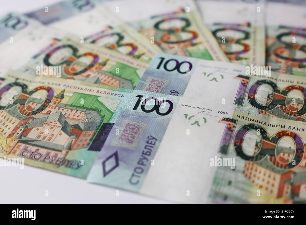 Banknotes of 100 belarusian rubles laid out on an isolated background Stock Photo