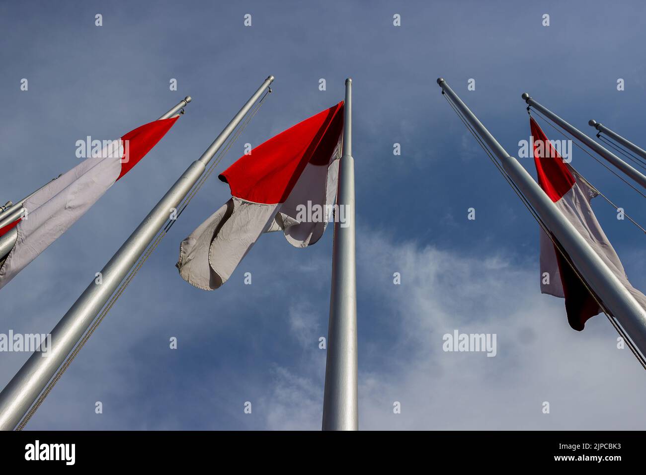 Indonesian flags fluttering in the sky on independence day Stock Photo