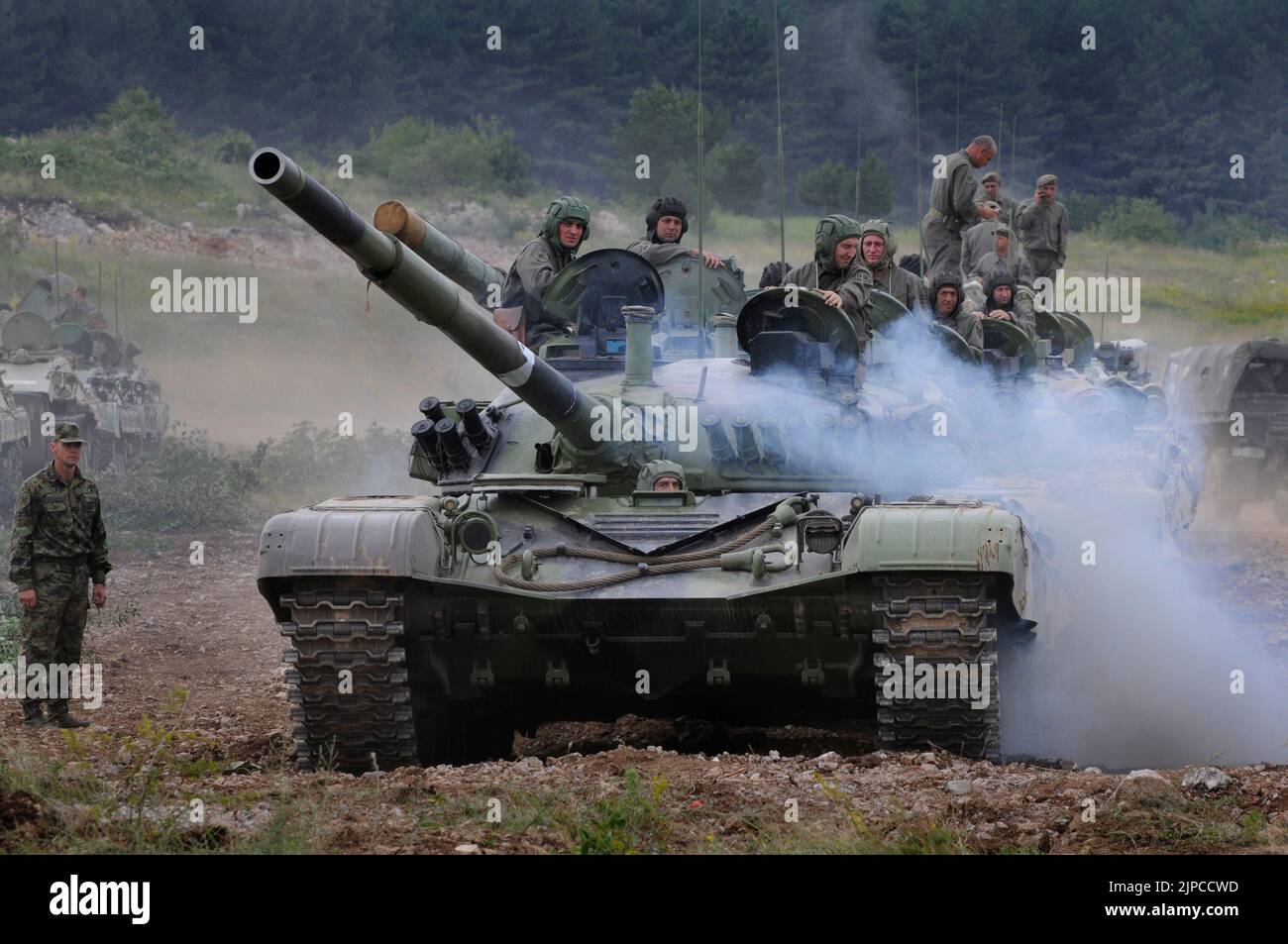 Serbian Army main battle tank M84 (version of Soviet T-72) and M80 armored personal carrier (APC) crews during exercise drill at military range Stock Photo