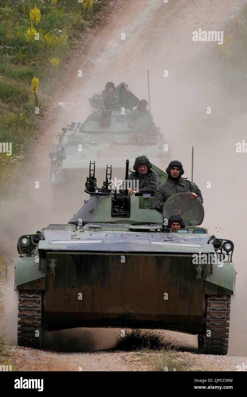 Serbian Army main battle tank M84 (version of Soviet T-72) and M80 armored personal carrier (APC) crews during exercise drill at military range Stock Photo