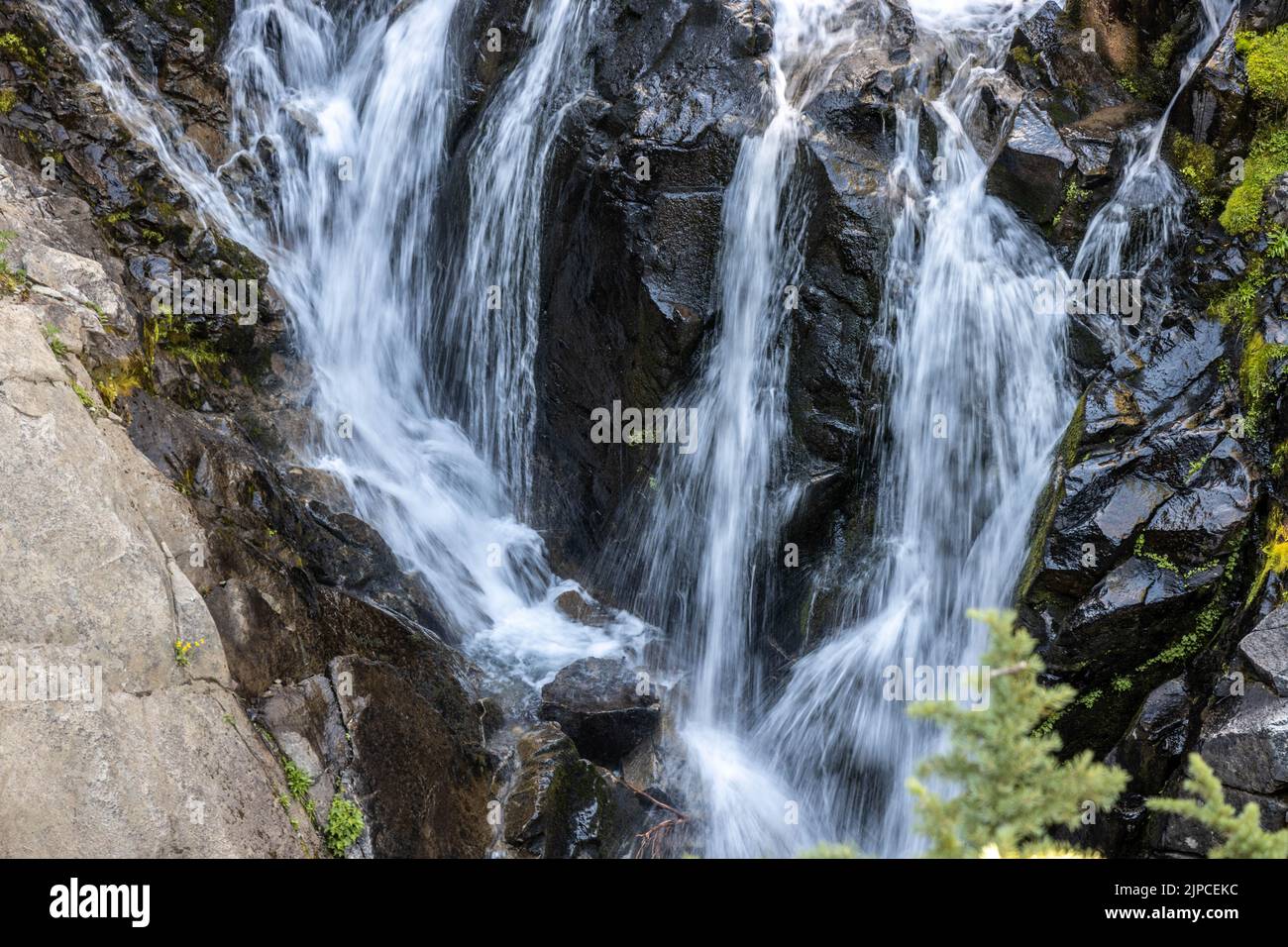 The long exposure of waterfalls flowing through the rocks Stock Photo