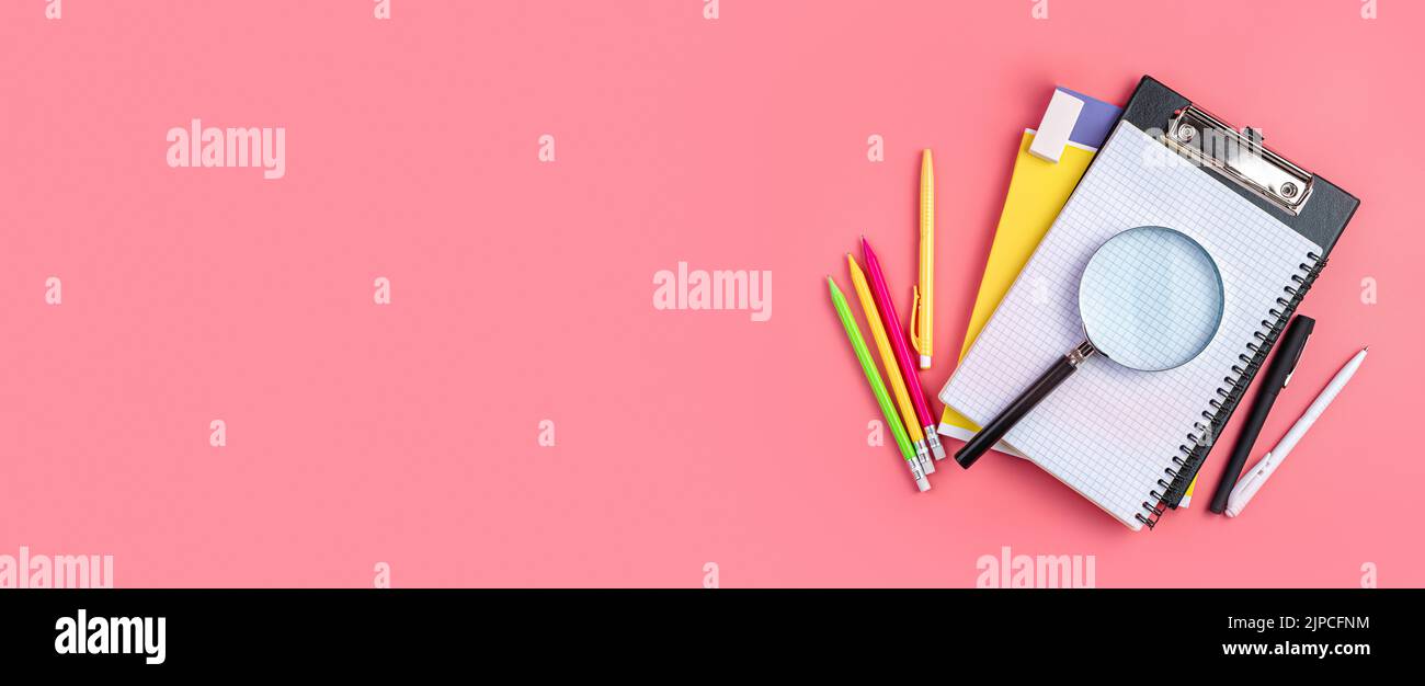 Background with school supplies on a pink background. Stock Photo