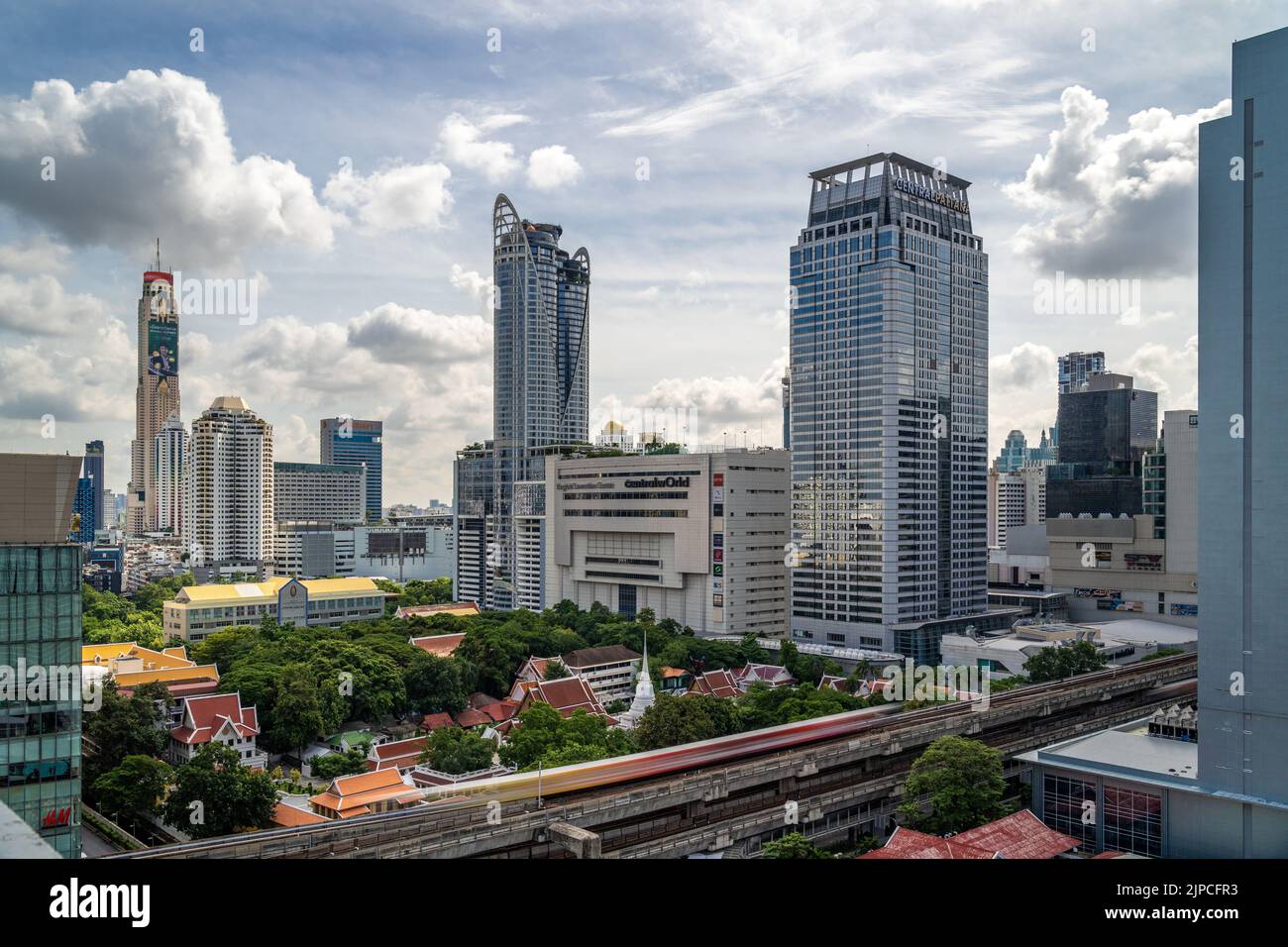 Bangkok, Thailand - 13 August 2022 - Aerial view of Bangkok cityscape with high-rises and white clouds in background Stock Photo