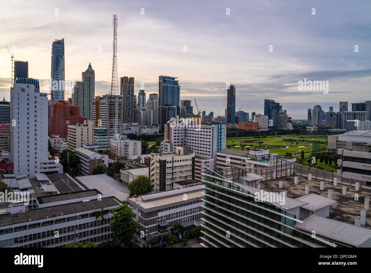 Bangkok, Thailand - 11 August 2022 - Aerial view of Bangkok cityscape in the morning before sunrise showing high-rises and cloudy blue sky Stock Photo