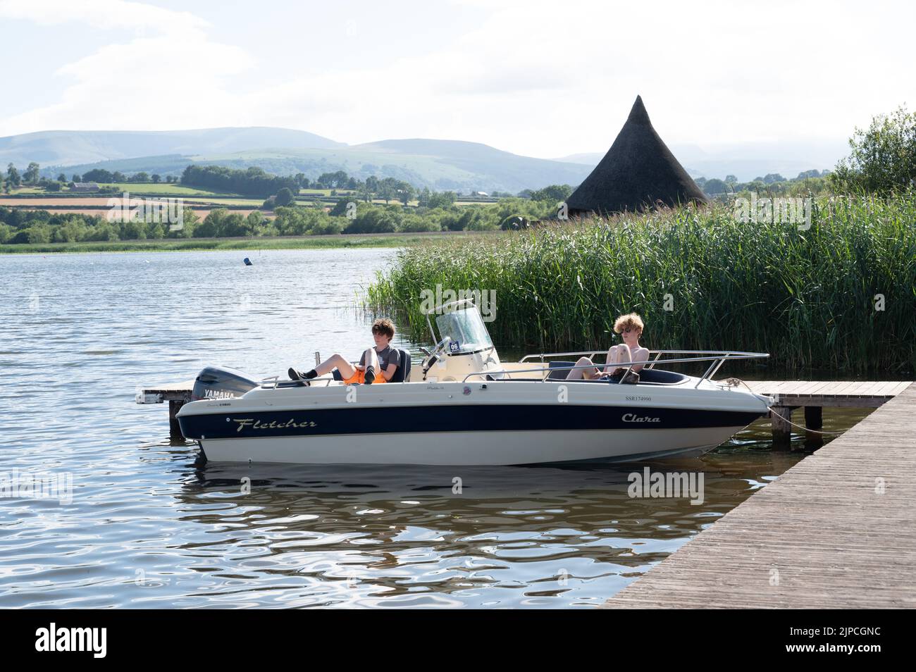 boys relaxing on a speedboat in Wales Stock Photo