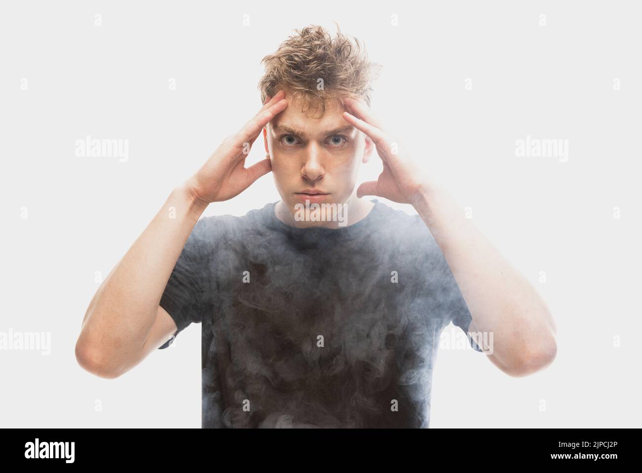 Mental pain. Young man in deep emotional shock isolated over white