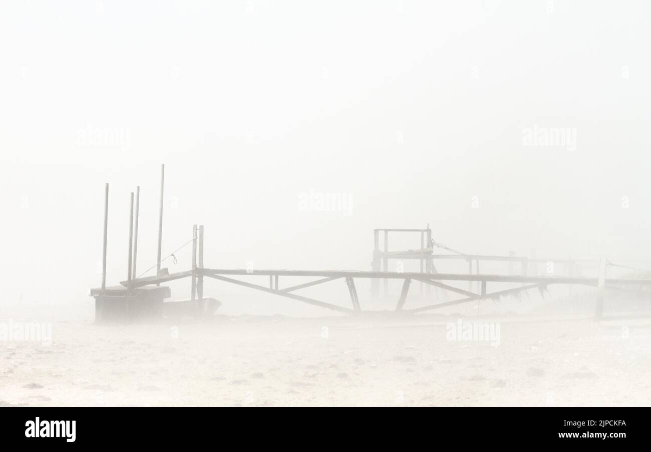 Old Wooden And Metal Jetty In The Sea Mist, Fog, Stanpit Creek, Christchurch UK Stock Photo