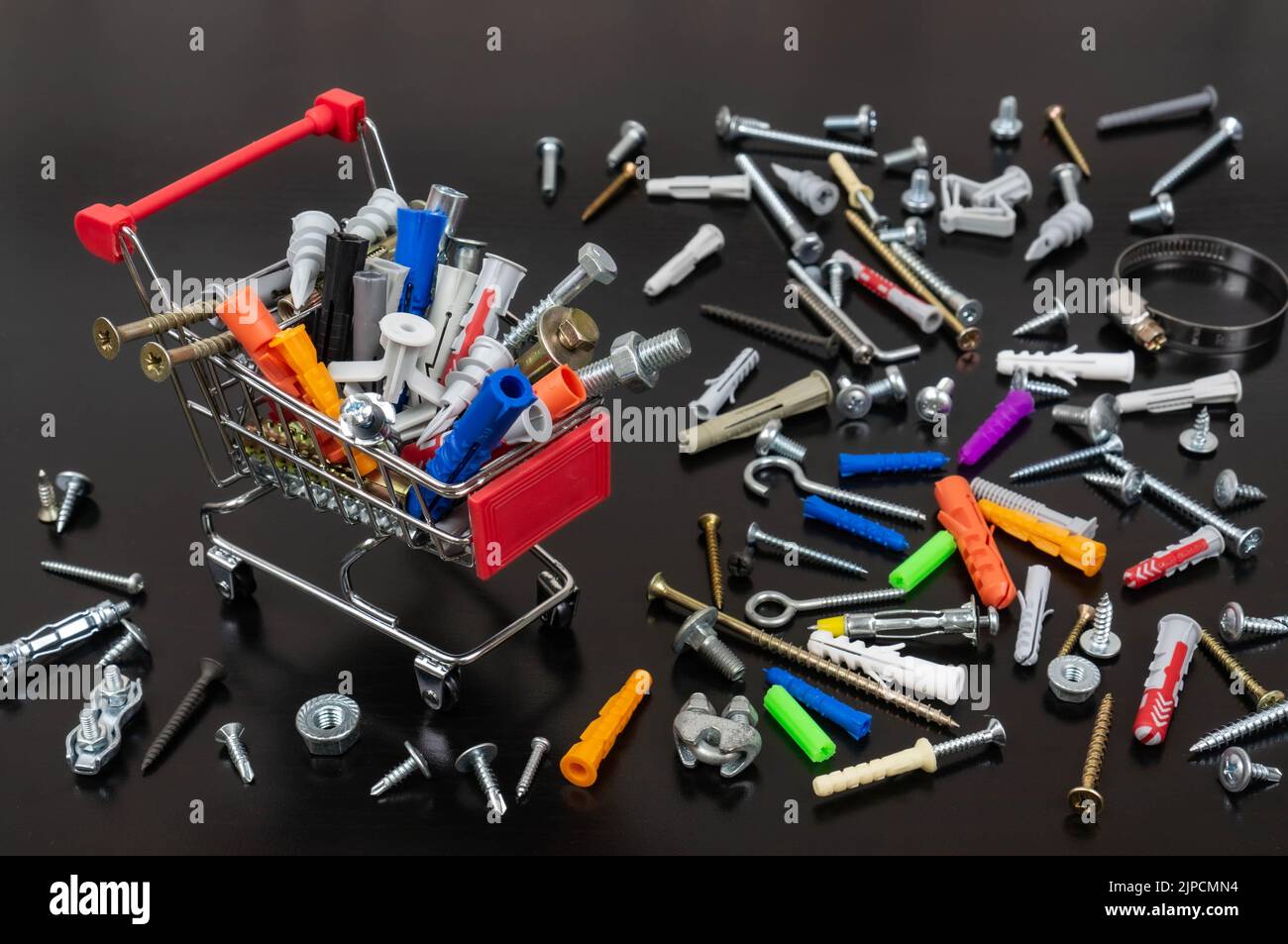 Different types of fasteners in a supermarket trolley. Place for text