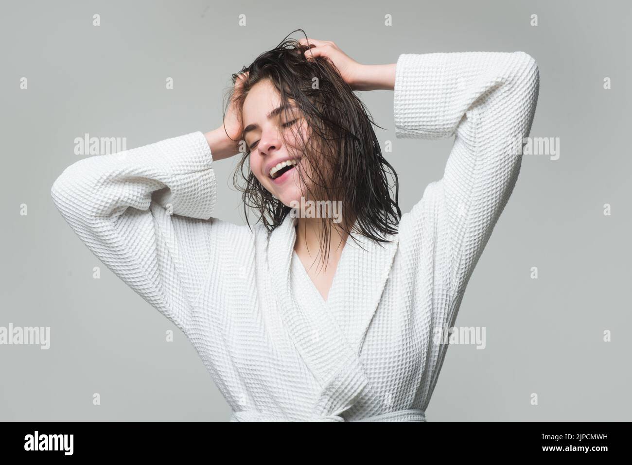 Beautiful caucasian woman posing with wet hair, after showering. Health