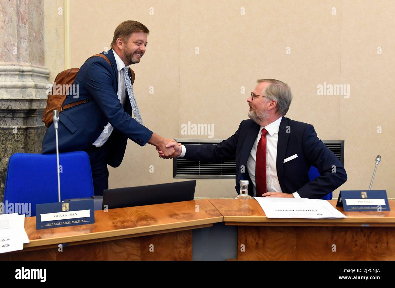Prague, Czech Republic. 17th Aug, 2022. Prime Minister Petr Fiala, right, and Interior Minister Vit Rakusan shake hands during the Czech government meeting in Prague, Czech Republic, August 17, 2022. Credit: Katerina Sulova/CTK Photo/Alamy Live News Stock Photo