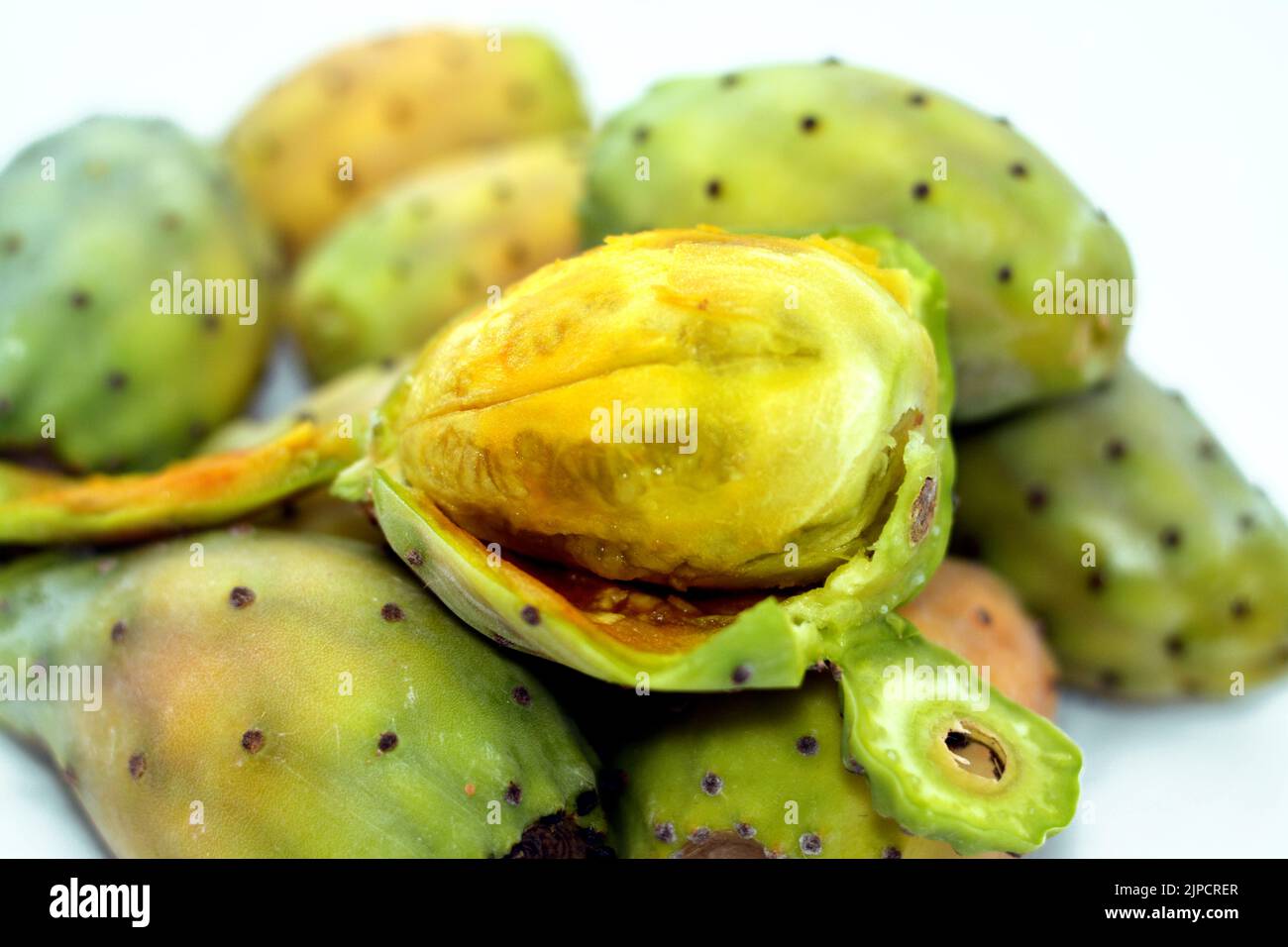 Pile of fresh prickly pear fruit isolated on white background, selective focus, Opuntia, commonly called prickly pear, Barbary fig, tuna fruit, sabra Stock Photo