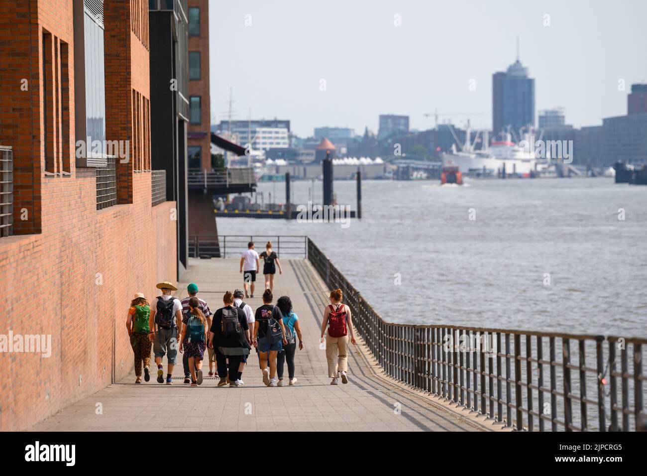 Hamburg, Germany. 17th Aug, 2022. Passers-by walk along a promenade on the Elbe. Credit: Jonas Walzberg/dpa/Alamy Live News Stock Photo