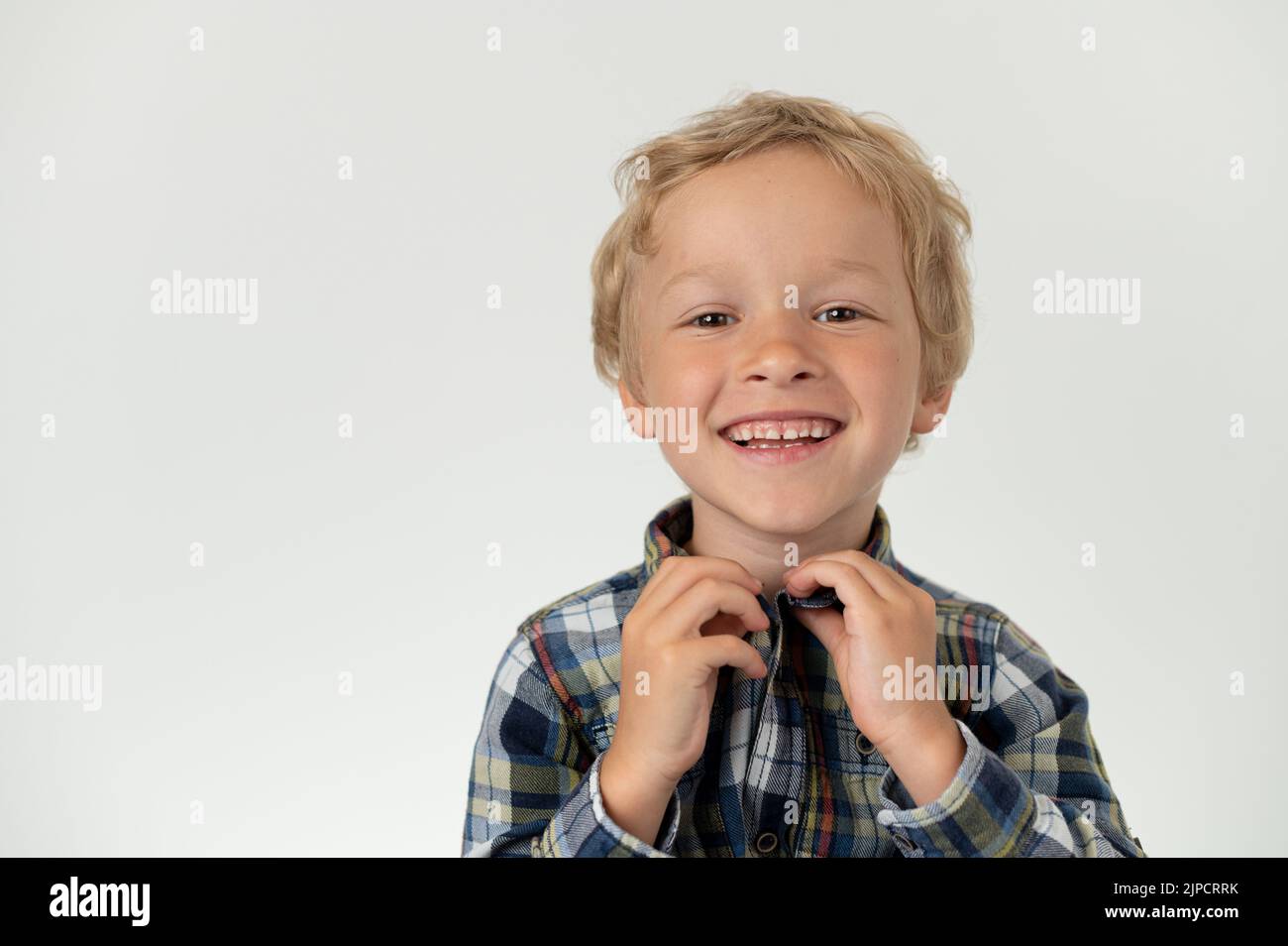 Boy deciding what cloth to put on Stock Photo