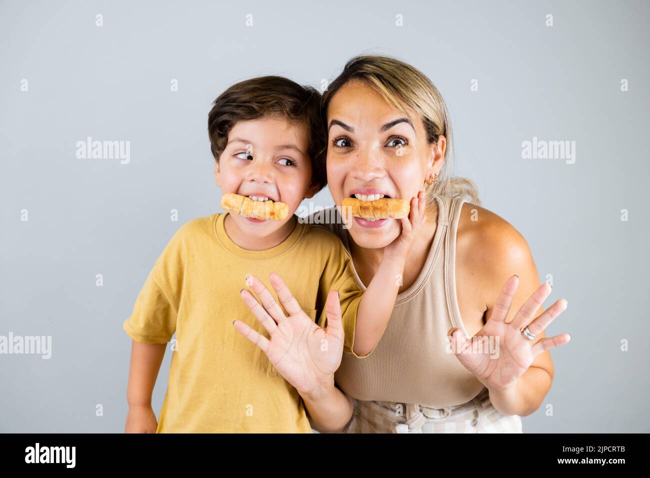 Mother and son enjoying and eating a Latin American snack called