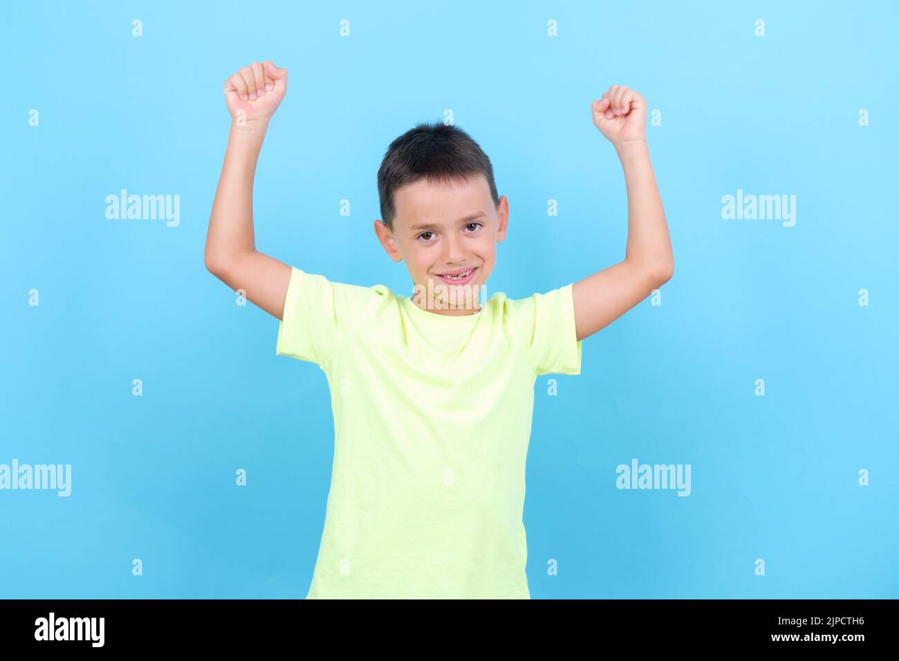 8-year-old boy is a winner and celebrates with his arms Stock Photo