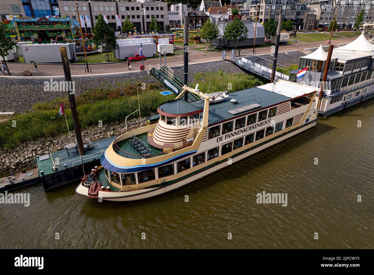 Floating pancake restaurant all you can eat Pannenkoekenboot at anchor seen from above on the shore of historic Hanseatic city of Nijmegen Stock Photo