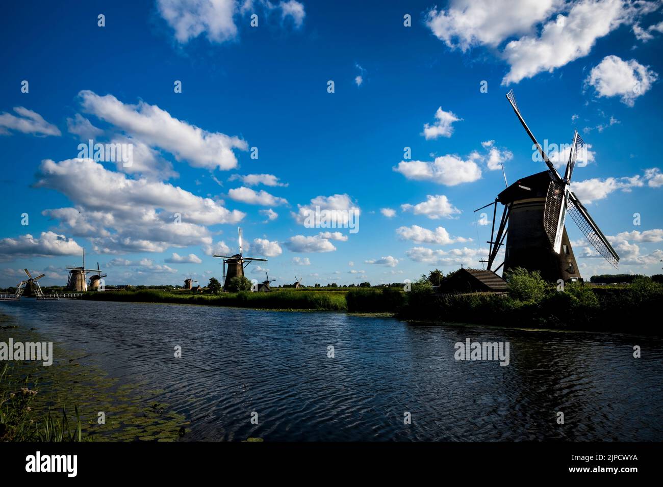 Historic windmills by the water at Kinderdijk in Holland Stock Photo