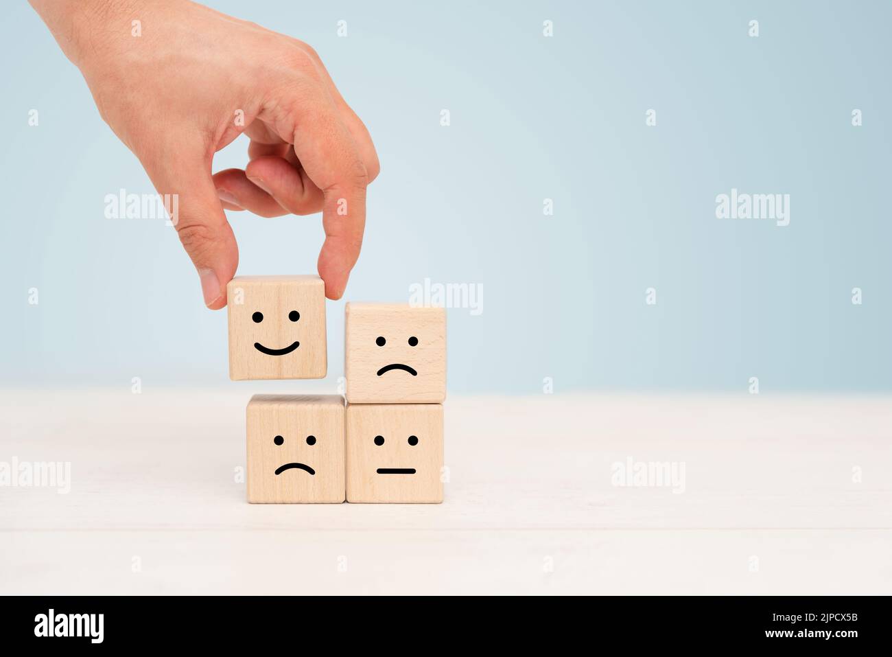 Wooden cube block, smile and sad emotions. Different emotions concept