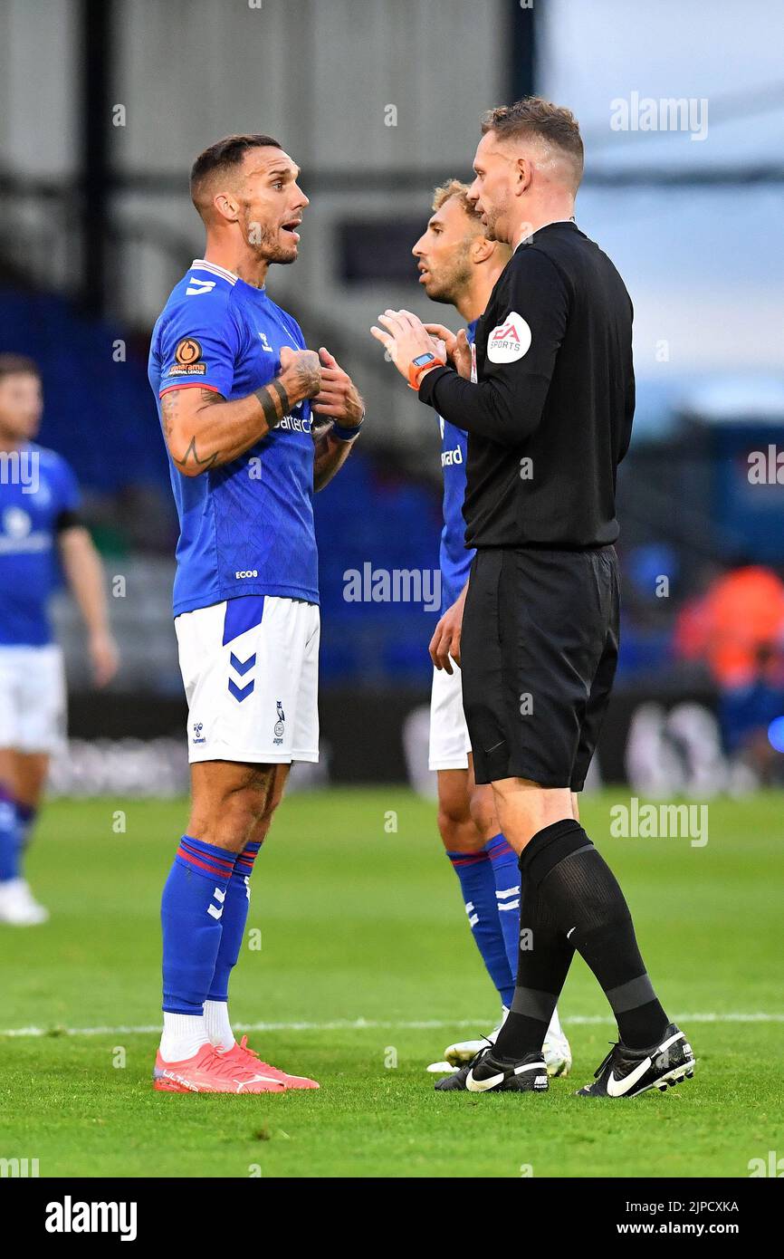 Liam Hogan (Captain) of Oldham Athletic converses with referee Andrew Miller during the Vanarama National League match between Oldham Athletic and Wealdstone at Boundary Park, Oldham on Wednesday 17th August 2022. (Credit: Eddie Garvey | MI News) Stock Photo