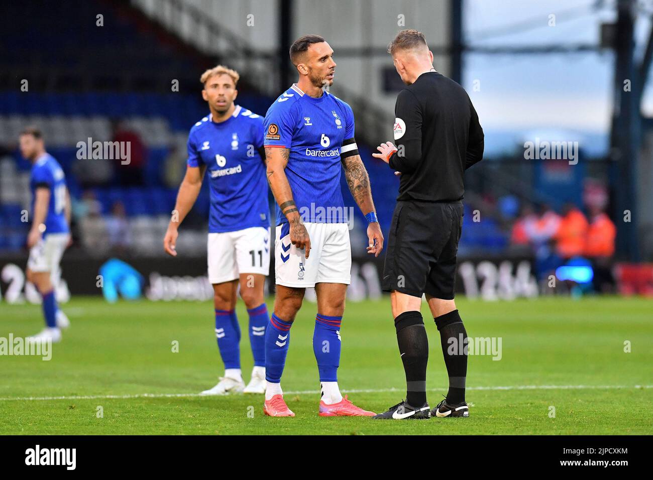 Liam Hogan (Captain) of Oldham Athletic converses with referee Andrew Miller during the Vanarama National League match between Oldham Athletic and Wealdstone at Boundary Park, Oldham on Wednesday 17th August 2022. (Credit: Eddie Garvey | MI News) Credit: MI News & Sport /Alamy Live News Stock Photo