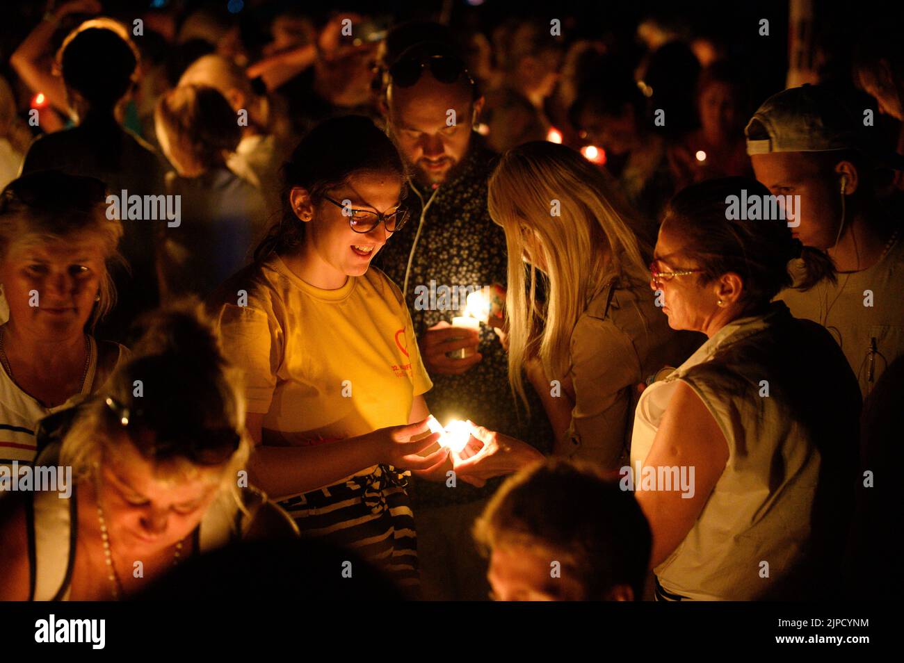 People lighting candles during the veneration of the Holy Cross after