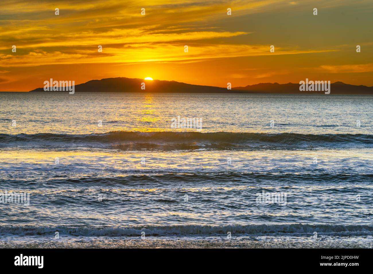 A beautiful view of the calm sea at the orange sunset, Hollywood Beach, California Stock Photo