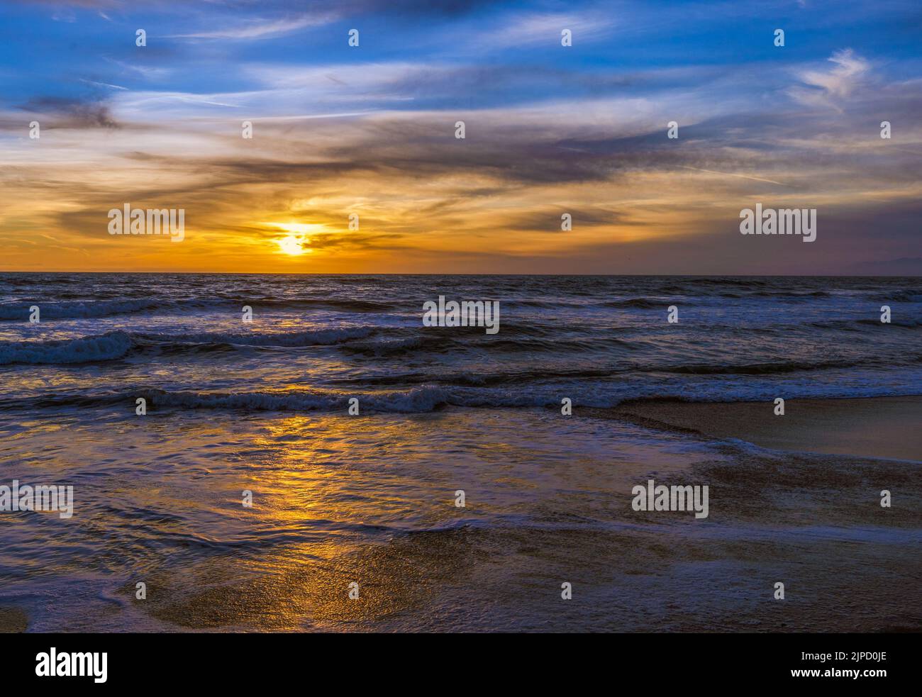 A beautiful view of the calm sea at the orange sunset, Hollywood Beach, California Stock Photo