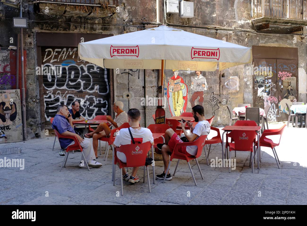 Italian men sitting at a cafe, bar, restaurant, in Naples, Napoli. Stock Photo
