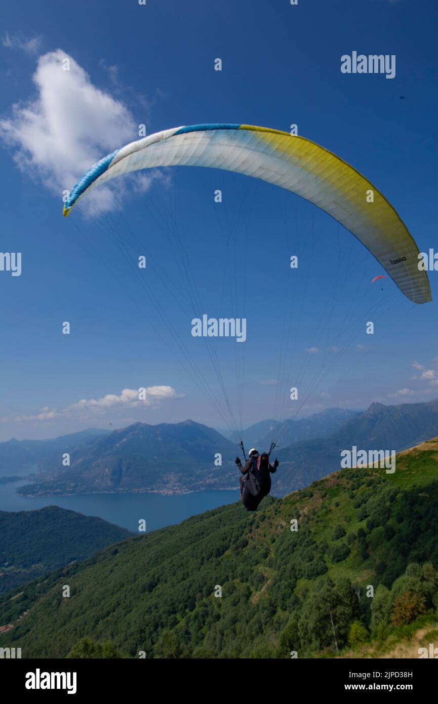 2022 august 11 - Europe, Italy, Lombardia, province of Lecco, Valsassina, Taceno, tandem and single paragliding school at Alpe Giumello in upper Valsa Stock Photo