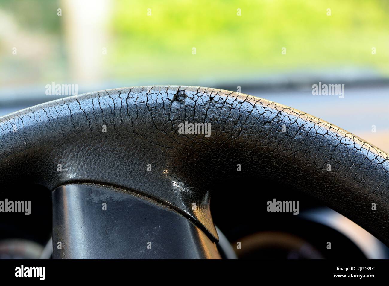 Selective focus of cracks and damaged rubber of the car steering wheel