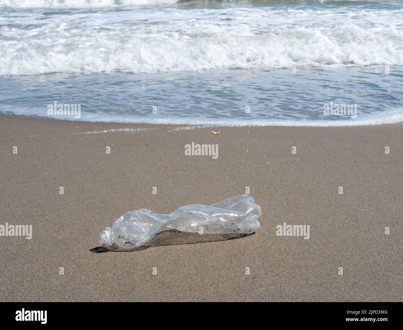 Plastic bottle on the beach Plastic garbage Stock Photo