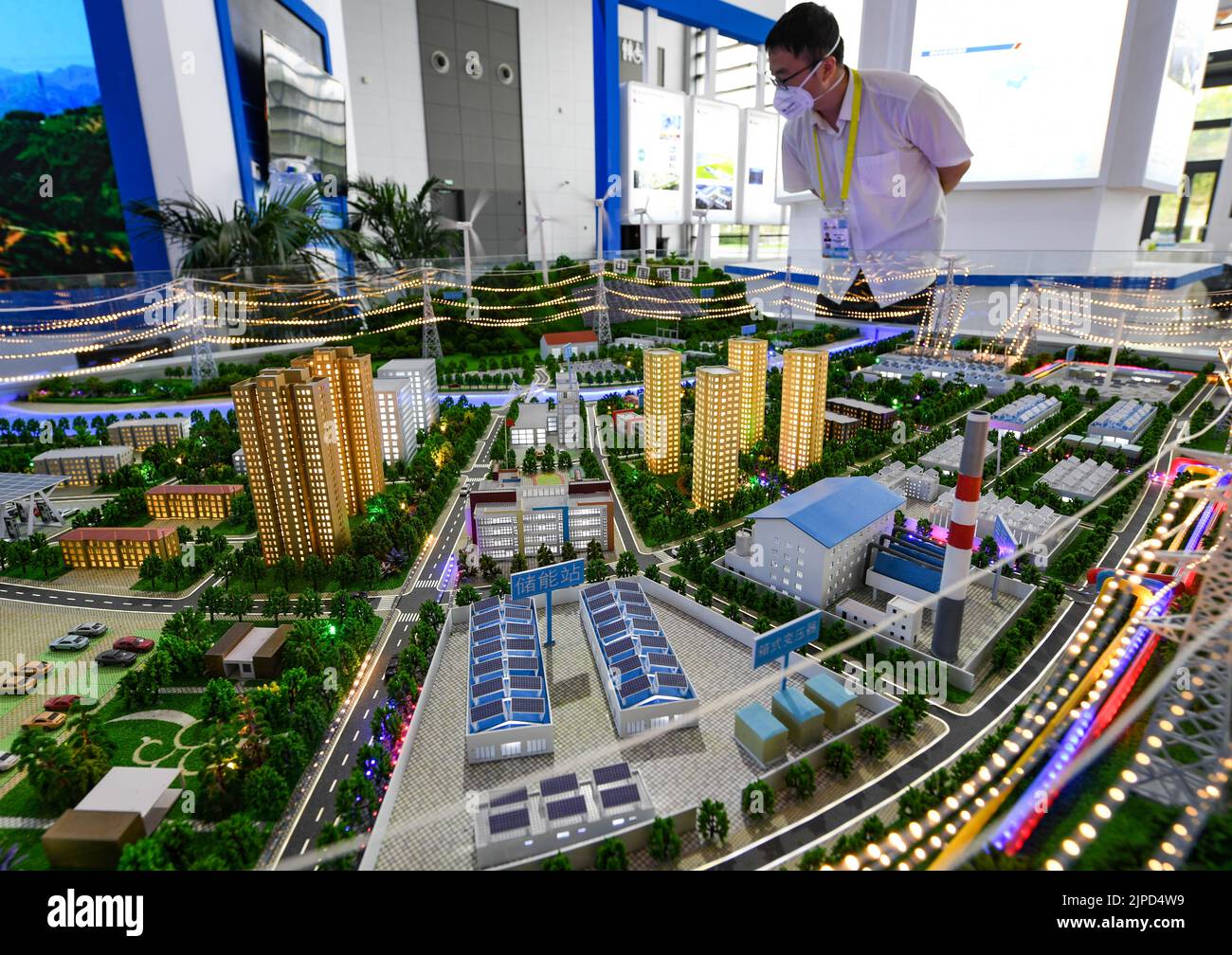 Xi'an, China's Shaanxi Province. 16th Aug, 2022. A staff checks a new energy project model at the booth of China Energy Engineering Group during the sixth Silk Road International Exposition in Xi'an, northwest China's Shaanxi Province, Aug. 16, 2022. Credit: Zou Jingyi/Xinhua/Alamy Live News Stock Photo