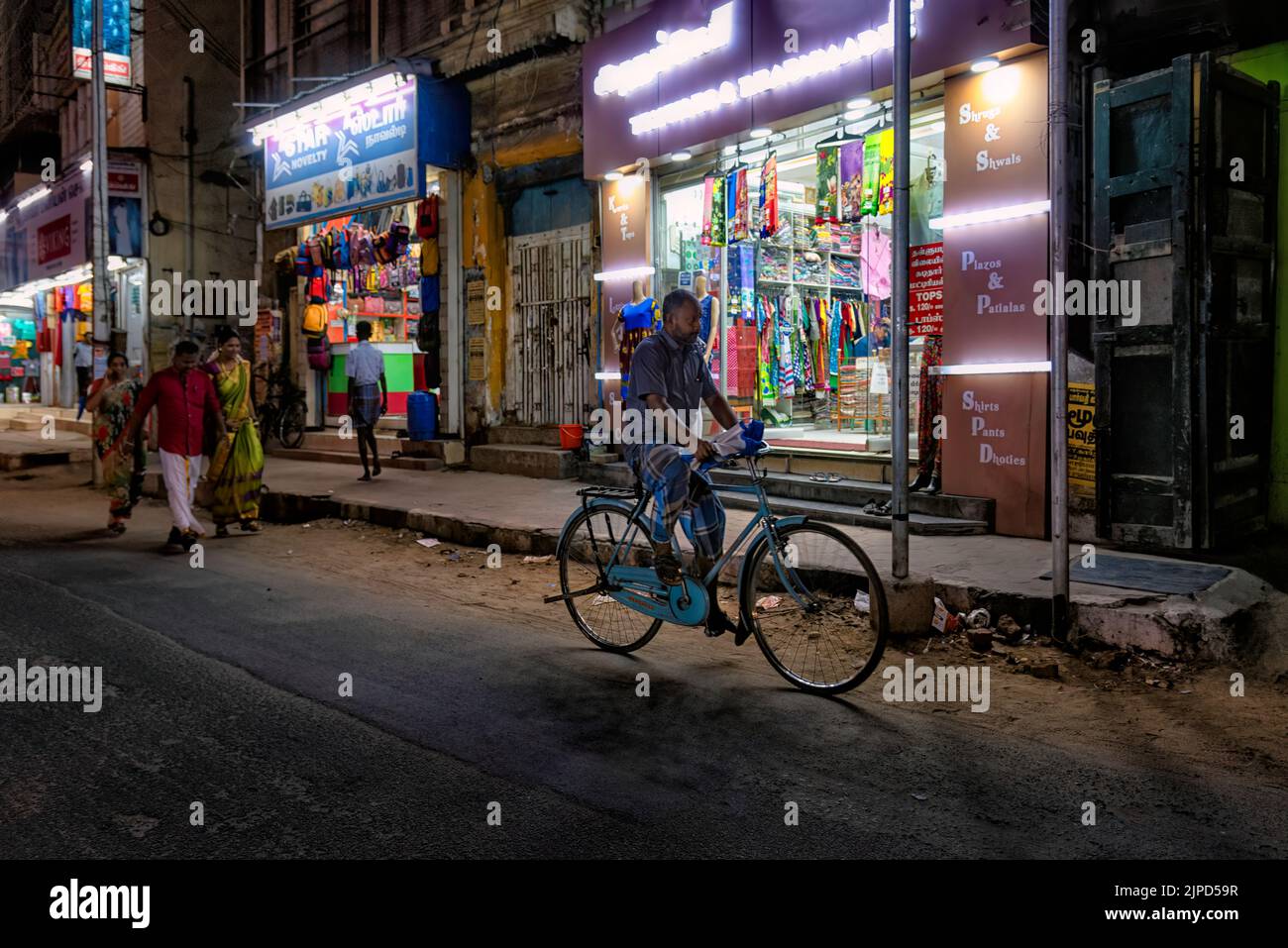 Madurai, India - August 23, 2018: Night view of a Madurai street with illuminated stores and people. Madurai is an important city of Tamil Nadu Stock Photo