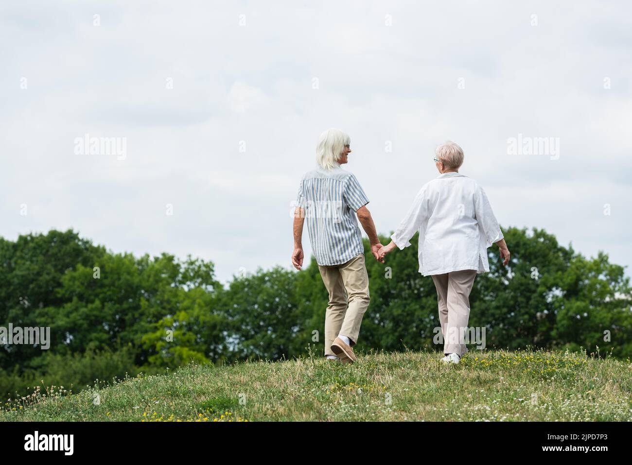 Pensioners walking holding hands hi-res stock photography and images ...