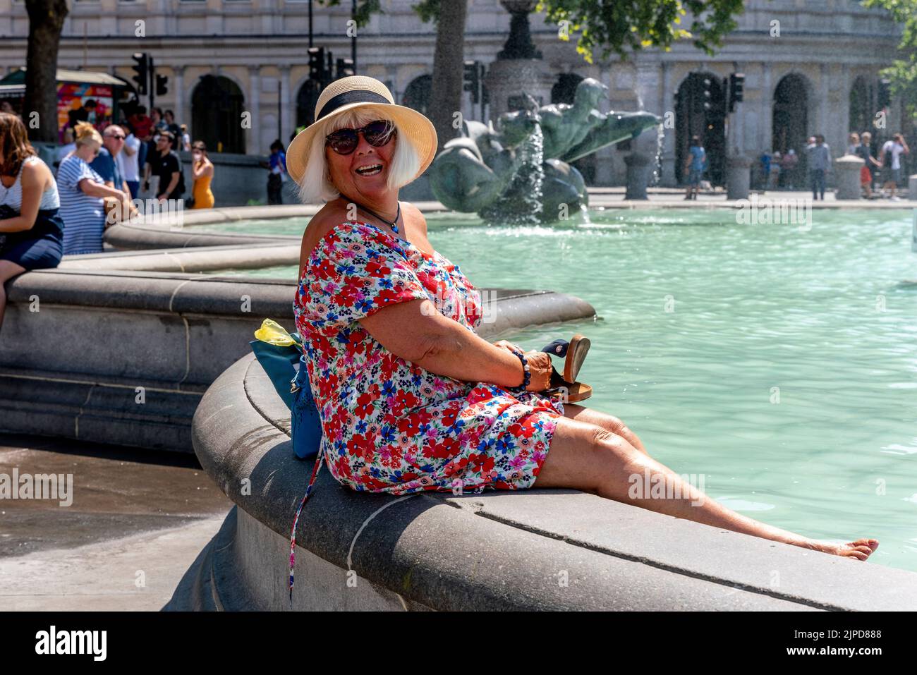 A Woman Cools Off In The Fountains In Trafalgar Square On The Hottest Day Ever Recorded, London, UK Stock Photo