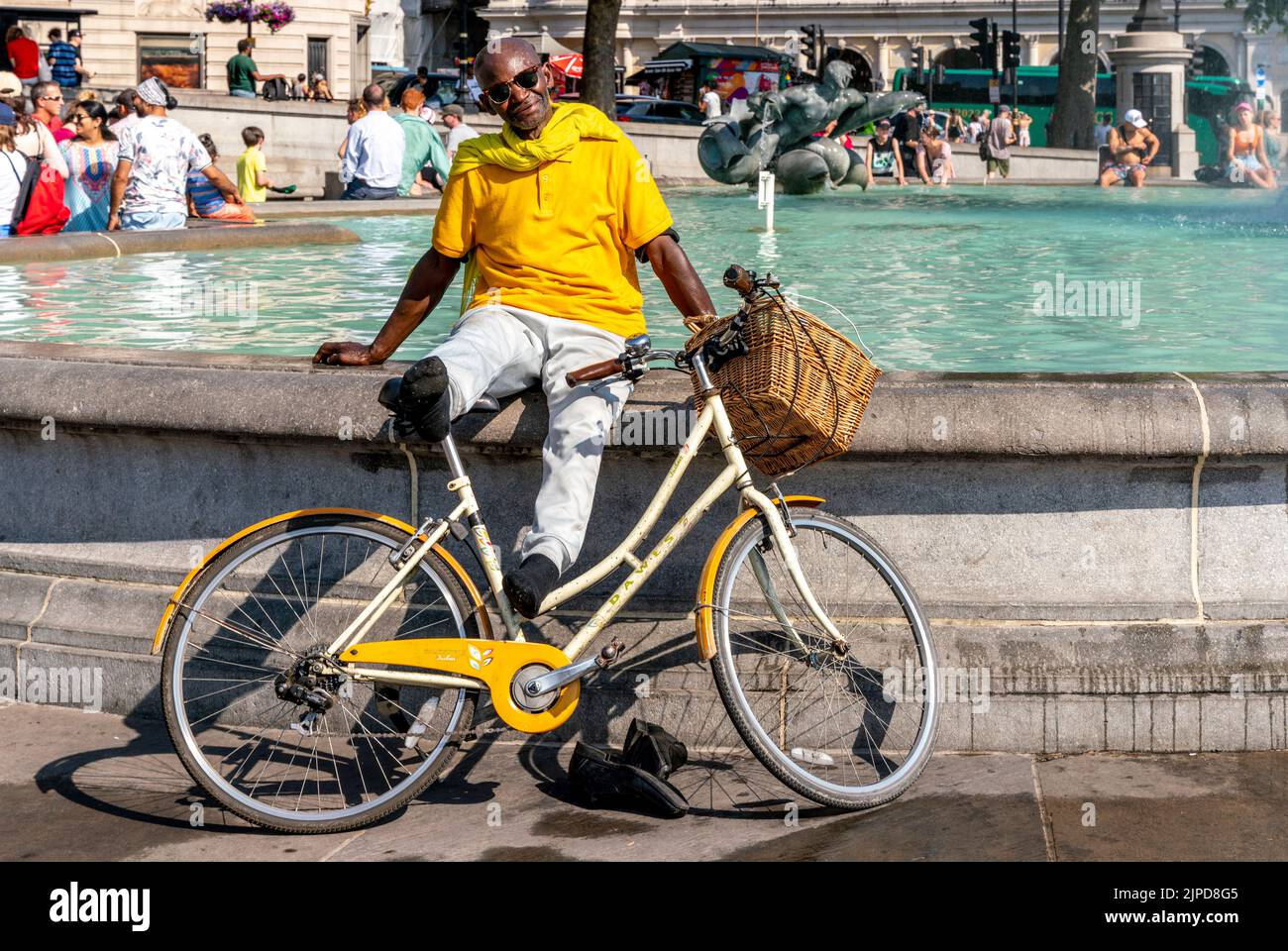 A Local Man Cools Off At The Fountains In Trafalgar Square During The Hottest Day Ever Recorded In The Capital, London, UK Stock Photo