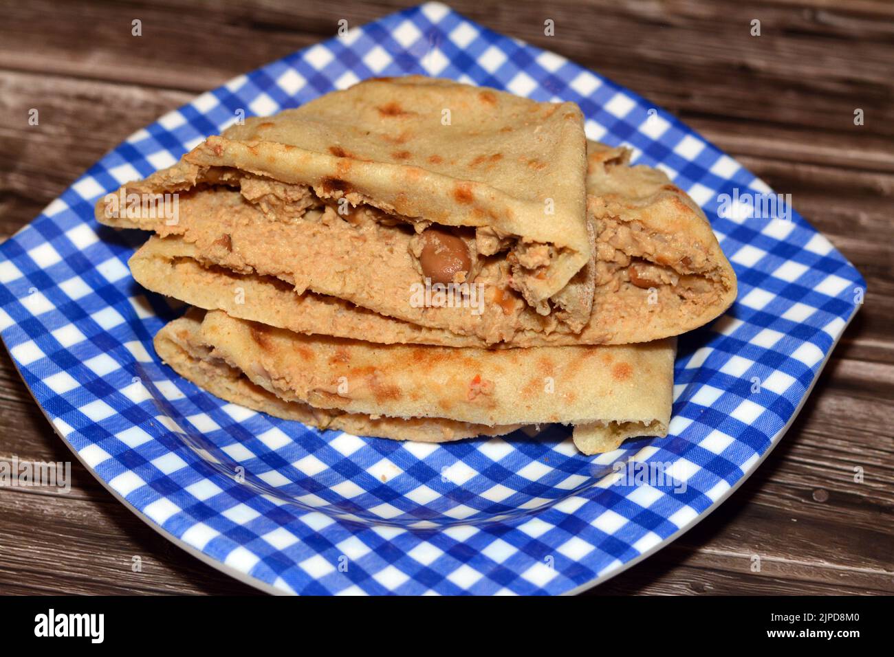 A flat bread with mashed fava beans mixed with oil, sesame tahini