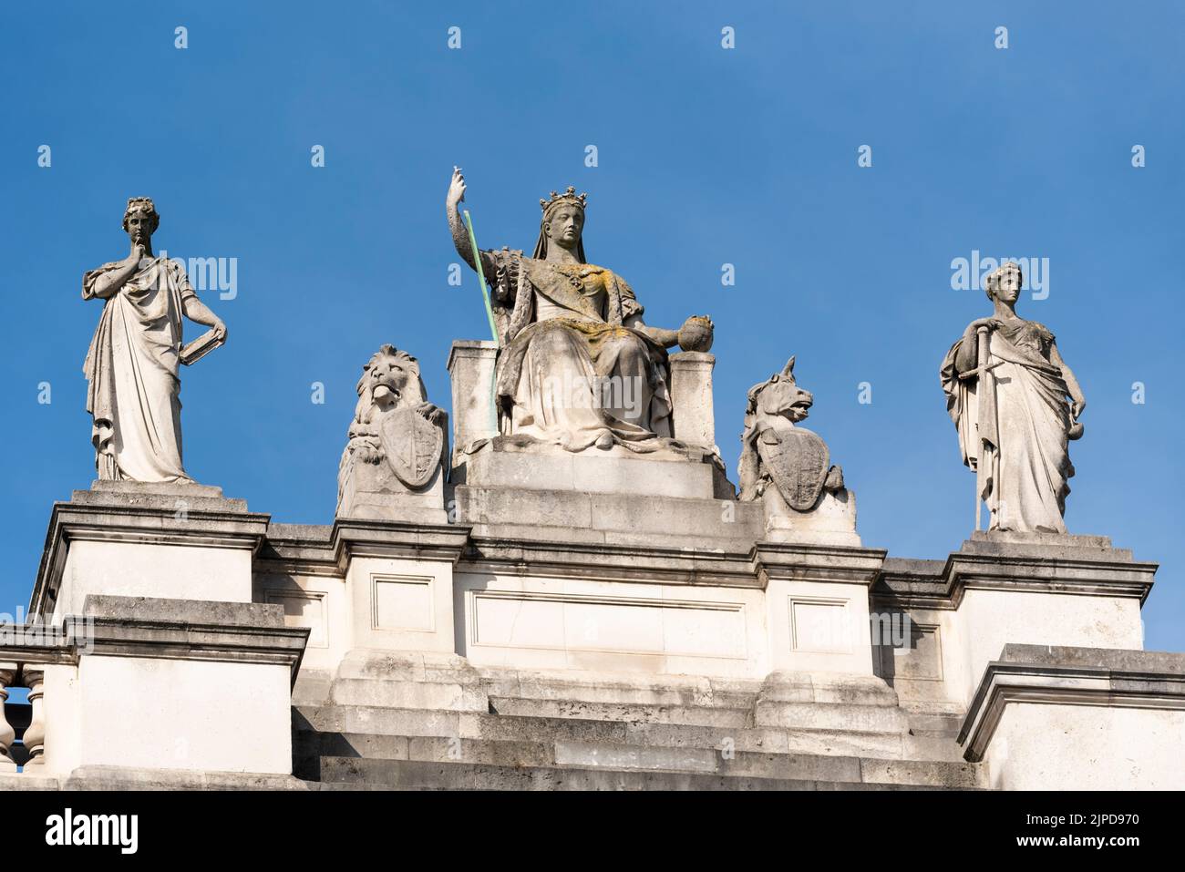 Britannia and her companions sculptures on the Foreign and Commonwealth Office Government building, London. Wisdom, Britannia, Justice figures Stock Photo