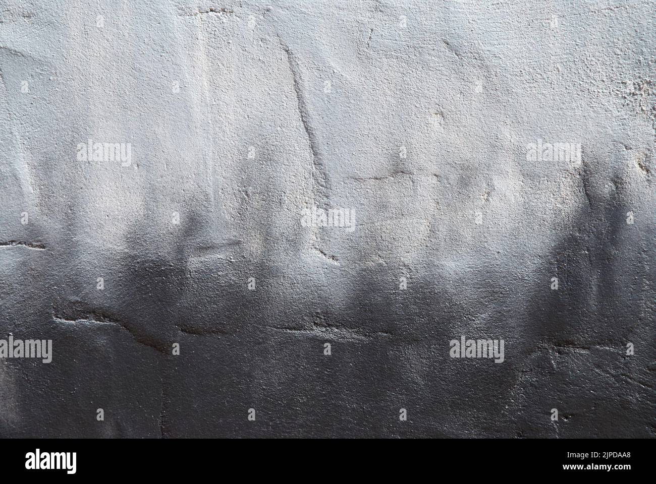 Closeup of a painted textured wall monotone grey Stock Photo