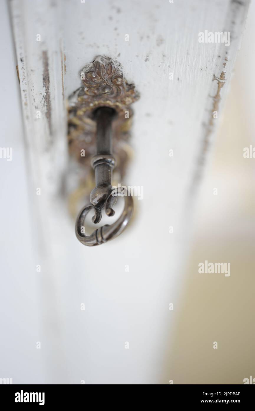 Brass ornate key in a decorative door frame Stock Photo - Alamy